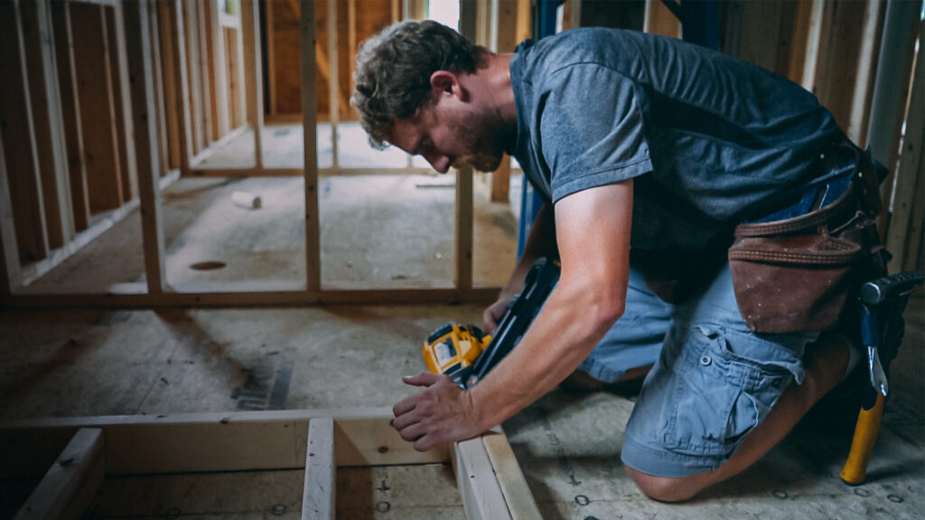 man-framing-a-wall-with-nail-gun