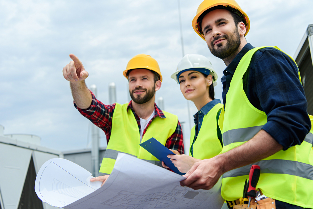 construction-people-on-a-job-site-with-paper-plans