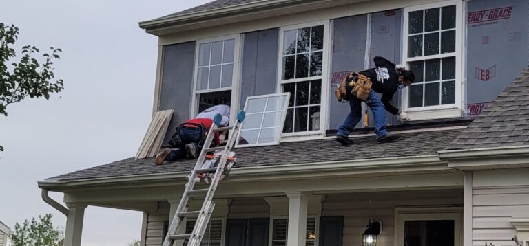 a-crew-of-handymen-installing-windows-on-roof-on-second-story-of-house