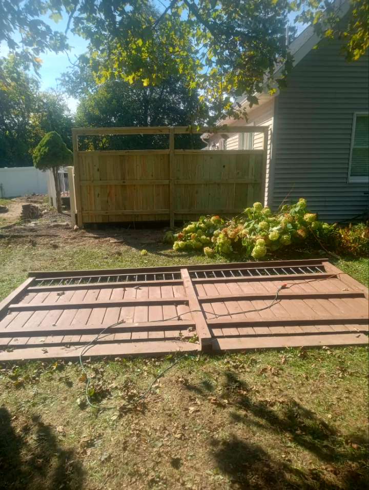 fence-laying-on-the-ground-near-flowers-in-summer-ready-to-be-put-up