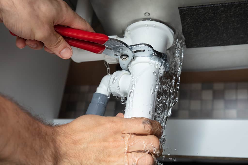plumber-using-a-wrench-to-fix-a-plumbing-fixture